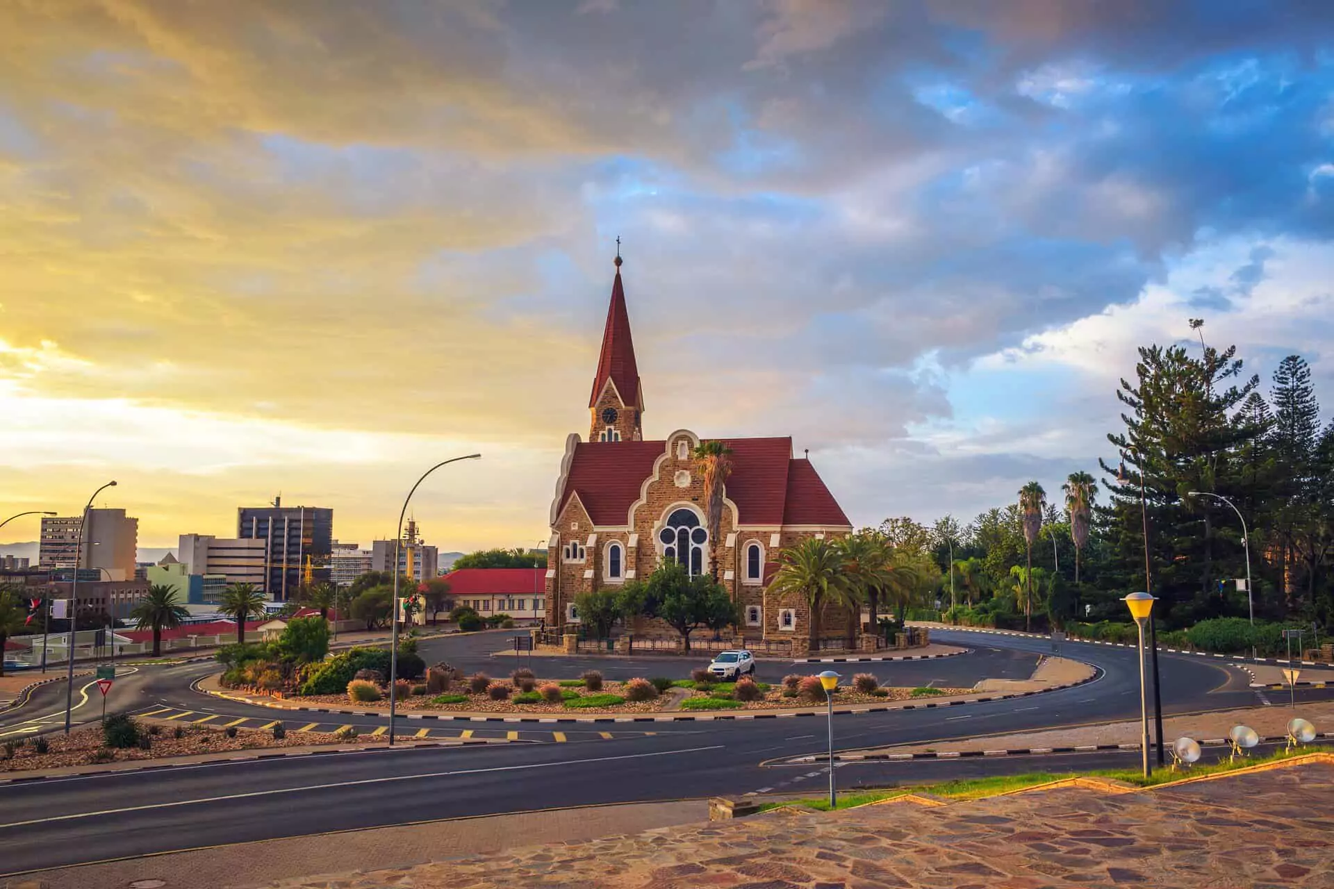 Vibrant view of Christuskirche, a top tourist attraction and destination in Namibia, surrounded by gardens.